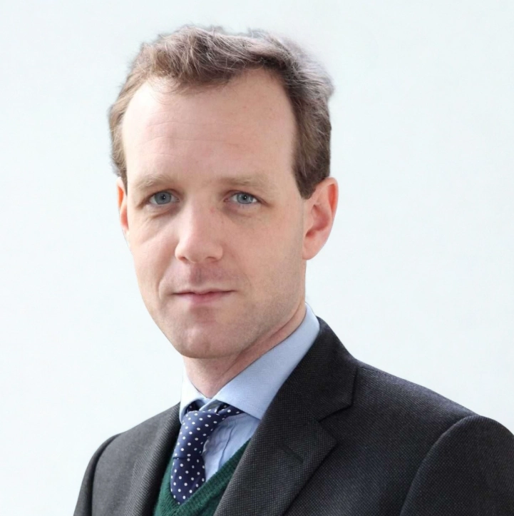 Dominic McCann's professional headshot against a white background