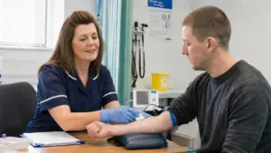 an addiction treatment nurse helping a male patient with his heroin detox